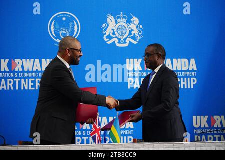 Home Secretary James Cleverly and Rwandan Minister of Foreign Affairs Vincent Biruta sign a new treaty. The treaty will address concerns by the Supreme Court, including assurances that Rwanda will not remove anybody transferred under the partnership to another country. Picture date: Tuesday December 5, 2023. Stock Photo