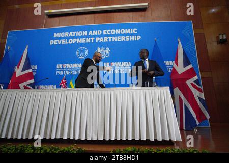 Home Secretary James Cleverly during a press conference with Rwandan Minister of Foreign Affairs Vincent Biruta after the signing of a new treaty in Kigali, Rwanda. The treaty will address concerns by the Supreme Court, including assurances that Rwanda will not remove anybody transferred under the partnership to another country. Picture date: Tuesday December 5, 2023. Stock Photo