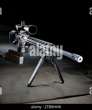 Precision bolt action rifle ideal for a sniper with ammunition with a mounted bipod on a shooting mat. Stock Photo