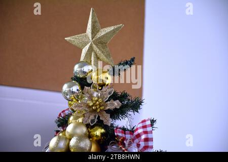 Golden Christmas balls with red decoration and golden star on top Stock Photo