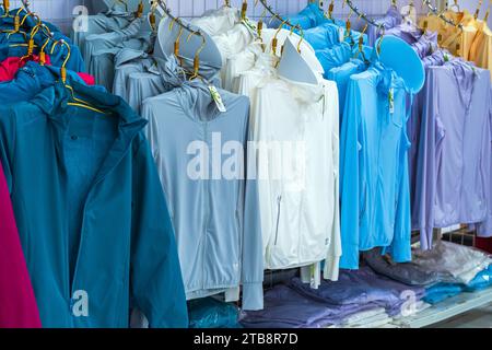 DA NANG CITY-VIETNAM, OCTOBER 14, 2023 : Variety of beautiful colorful sport jackets made from bamboo pulp for good health hanging for sale in shoppin Stock Photo