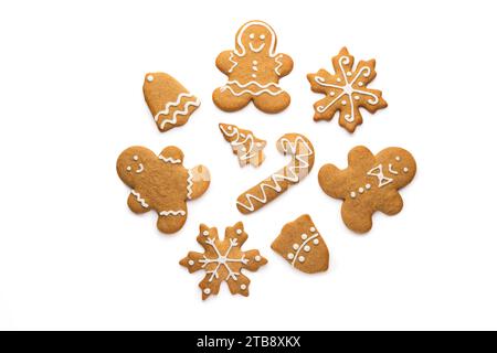 Christmas homemade gingerbread cookies of a man, snowflake, bell, star and tree with icing isolated on white background Stock Photo
