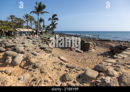 Gran Canaria, Spain - November 23, 2023: Maspalomas  Lighthouse in Gran Canaria, spain,  at the promenade with tourists and the Punta Mujeres Archaeol Stock Photo