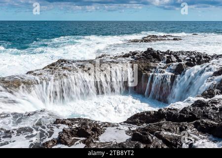 Spectacular natural phenomenon of Bufadero de la Garita where the water goes up and down in the hole like a waterfall with every wave, Gran Canaria is Stock Photo