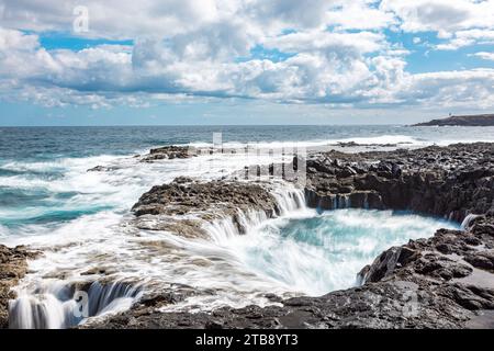 Spectacular natural phenomenon of Bufadero de la Garita where the water goes up and down in the hole like a waterfall with every wave, Gran Canaria is Stock Photo