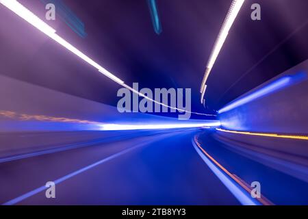 Blue and purple abstract high speed curved movement toward to the future, just around the corner, concept of lights and a tunnel. Stock Photo