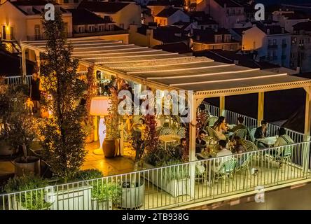 The café of the terrace at night at the Portas Do Sol viewpoint overlooking the old town Alfama District of Lisbon Portuga Stock Photo