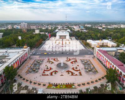 Bishkek, Kyrgyzstan - July 15, 2023: Aerial view of Bishkek city's Ala-Too central square with waving flag Stock Photo