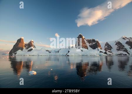 Reflections of cliffs and mountains in the Lemaire Channel; Antarctica Stock Photo