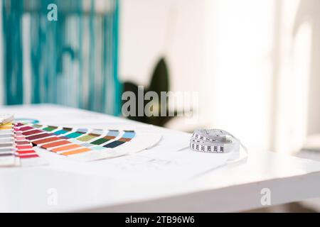 Color swatch palette and tape measure on table in fashion shop sewing tools and supplies Stock Photo