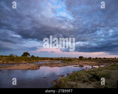 Scenic sunset at the edge of Mara river in Serengeti National Park; Kogatende, Tanzania Stock Photo