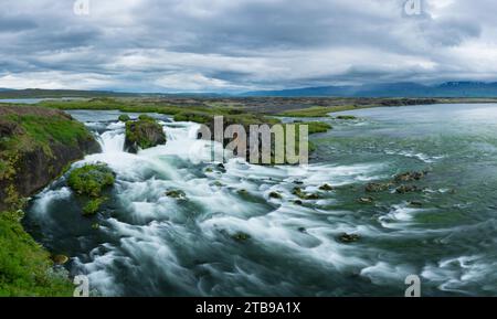 Scenic view of waterfalls at the mouth of the Myrarkvisl river along the northern coast of Iceland, near Husavik; Iceland Stock Photo