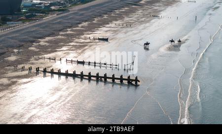 Bracklesham Bay on a sunny summer morning. Elevated view showing the great beach and seaside landscape. Groynes protecting the beach from erosion. Stock Photo