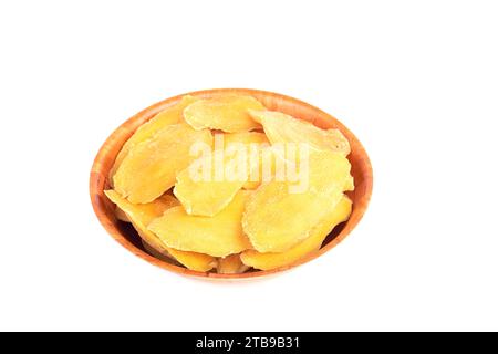 Dried mango slices in a bowl over a white background. Copy space. Stock Photo