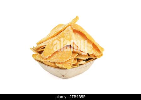 Sliced dried mango slices in a wooden bowl isolated on a white background. Copy space. Stock Photo