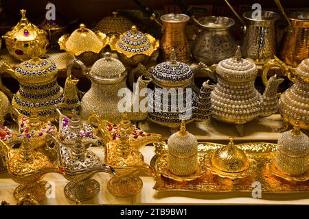 Decorative teapots and traditional Turkish oil lamps for sale in brass, copper and bedazzeled with gems on display in a shop in the Spice Bazaar in... Stock Photo