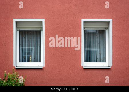 Two rectangular windows with a white frame against a pink plastered wall. From the Windows of the world series. Stock Photo
