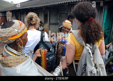 Bonda people are selling traditional ornaments to foreigners. The Bonda, also known as Remo, are a Munda ethnic group who live in the isolated hill regions of the Malkangiri district of southwestern Odisha, near the junction of the three states of Odisha, Chhattisgarh, and Andhra Pradesh. The tribe is one of the oldest and most primitive in mainland India; their culture has changed little for more than a thousand years. They are one of the 75 Primitive Tribal Groups identified by the Government of India. Stock Photo