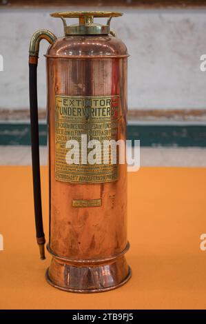 old copper colored post war fire extinguisher Stock Photo