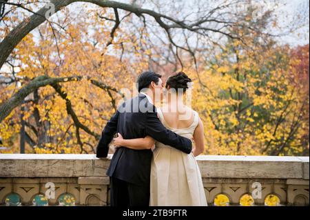 Bride and groom embrace on their wedding day on a beautiful autumn day; Washington, District of Columbia, United States of America Stock Photo
