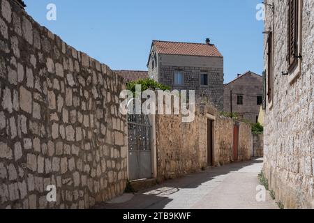 Street view of empty streets and alleyways lined with tradional stone residential houses in Vis in Croatia Stock Photo