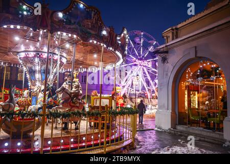 Gliwice, Poland. 5th Dec, 2023. Old fashioned French carousel and a ferris wheel are seen during Christmas market at the main square in Gliwice, Poland on December 5, 2023. (Credit Image: © Beata Zawrzel/ZUMA Press Wire) EDITORIAL USAGE ONLY! Not for Commercial USAGE! Credit: ZUMA Press, Inc./Alamy Live News Stock Photo