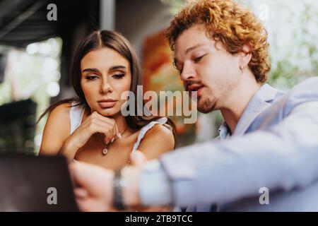 Architects, designers, and engineers discuss project finances and materials, collaborating on sustainable design and urban planning. Stock Photo