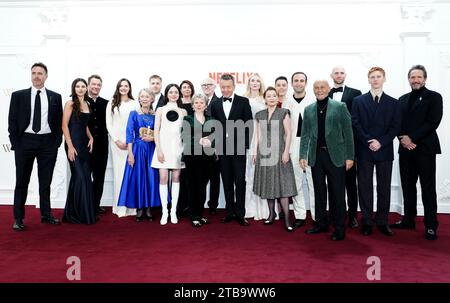 (left to right) James Murray, Beau Gadsdon, Dominic West, Meg Bellamy, Ed McVey, Marcia Warren, Madeleine Arthur, Claudia Harrison, Jonathan Pryce, Imelda Staunton, Elizabeth Debicki, Bertie Carvel, Lesley Manville, Olivia Williams, Khalid Abdalla, Salim Daw, Sebastian Blunt and Luther Ford arrive for the Crown finale celebration at the Royal Festival Hall in London. Picture date: Tuesday December 5, 2023. Stock Photo