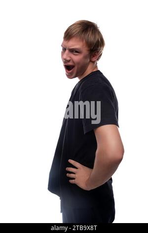 Charismatic teenage guy with blond hair makes a grimace Stock Photo