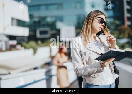 Business team brainstorming and collaborating on innovative ideas in a bustling urban city, led by a dynamic woman. Stock Photo