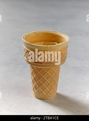 empty ice cream waffle cone on table top Stock Photo