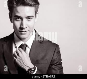 Portrait of handsome young man wearing suit and tie in studio fashion shoot Stock Photo