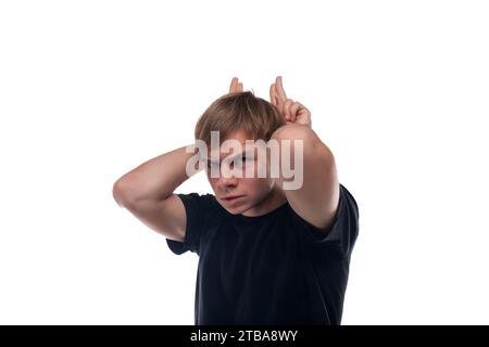 Blonde teenager dressed in a basic t-shirt makes a face Stock Photo