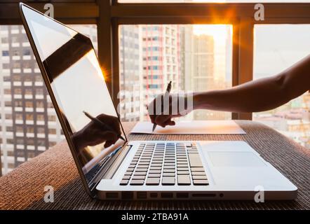 Person writing working in office city setting Stock Photo