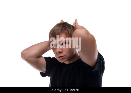 Caucasian guy with blond hair makes a face and horns Stock Photo