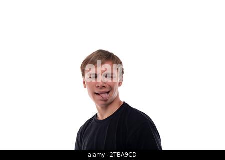 Caucasian guy with blond hair makes a face and shows his tongue Stock Photo