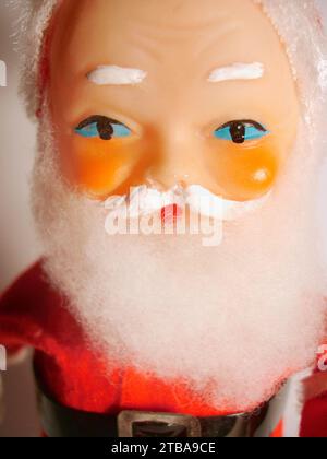 Close up a vintage Father Christmas tin toy. Full traditional Santa costume with trademark white moustache and beard and rosey cheeks. Stock Photo