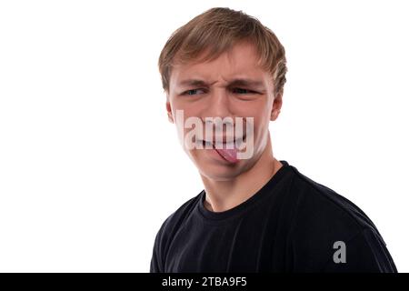 Blond teenager boy makes a grimace Stock Photo