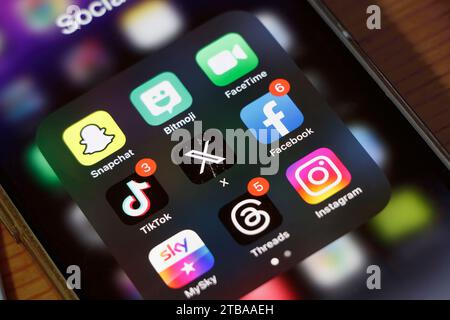Close-up apple iphone smartphone screen showing  social media messaging app icons including Snapchat, Bitmoji, FaceTime, Facebook, TikTok, Instagram Stock Photo