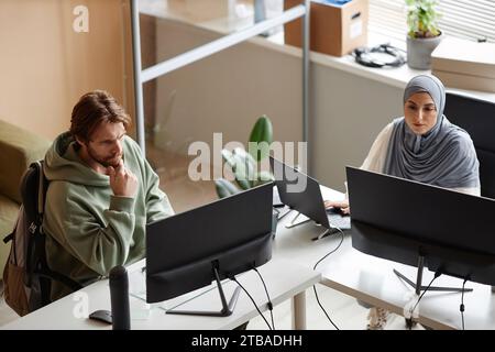 High angle view at two people using computers at workplace in office with wall separations Stock Photo