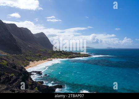 View from Makapuu Lookout on Oahu, Hawaii, with turquoise waters and white-sand beach in foreground, and clouds gathering in the distance. Stock Photo