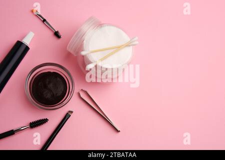 Flat lay composition with eyebrow henna and tools on pink background. Space for text Stock Photo