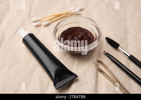 Eyebrow henna and tools on crumpled paper, closeup Stock Photo