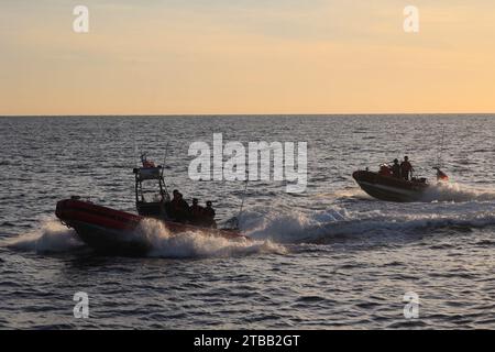 The crew of the U.S. Coast Guard Cutter Tahoma (WMEC 908) conducts interdiction operations with the cutter’s small boats in the Florida Straits, Nov. 6, 2023. Tahoma deployed for a 65-day patrol and conducted maritime safety and security missions while supporting Homeland Security Task Force – Southeast.  (U.S. Coast Guard photo by Petty Officer 2nd Class Christopher Hurst) Stock Photo