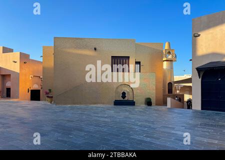 Exterior of the facade and minaret of the Golden Mosque of Katara, effectively covered in gold Stock Photo