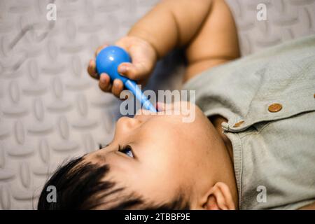 little baby practicing brushing teeth on his own. Kid brushes teeth. Oral hygiene Stock Photo