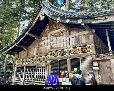 The Sacred Stable at Nikko Toshogu Shrine in Nikko, Japan. This building is best known for the 'Three Wise Monkeys' sculpture on its panel. Stock Photo