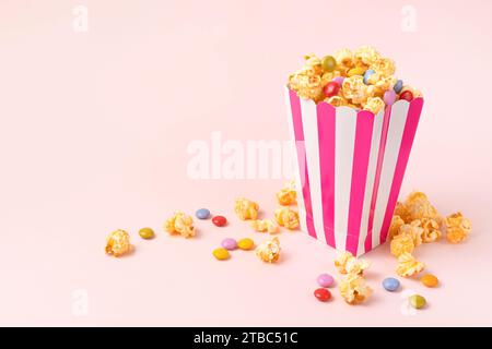 sweet popcorn with dragee on pink background Stock Photo