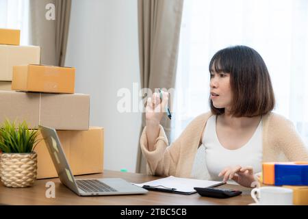 A young woman who owns a small online business from home. Stock Photo