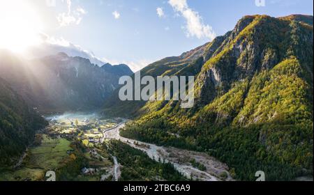 Aerial Panorama over Theth Village in the Northern Albanian Alps with Beautiful Sunbeams Stock Photo